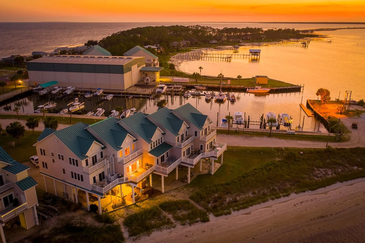 Aerial Real Estate photo of a view of a beach front condo at sunset.