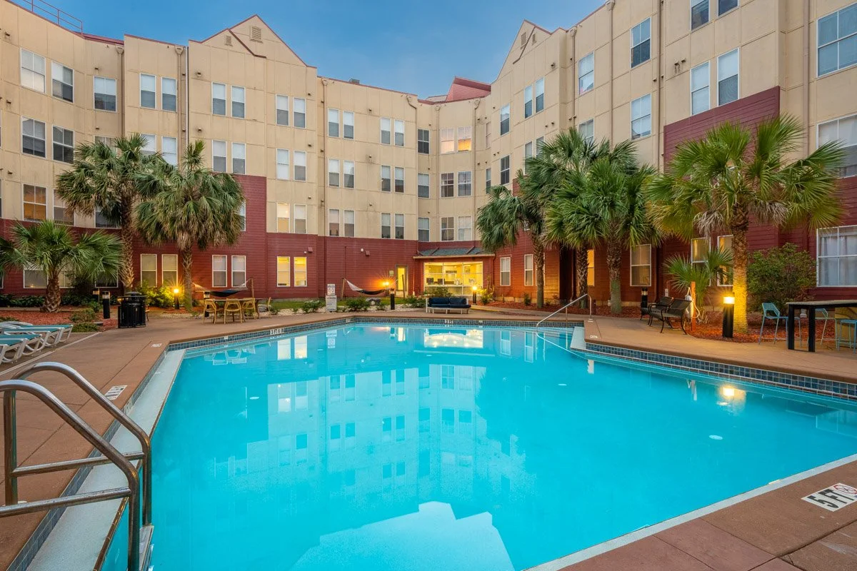 Commercial real estate photo of an apartment complex swimming pool taken at dusk