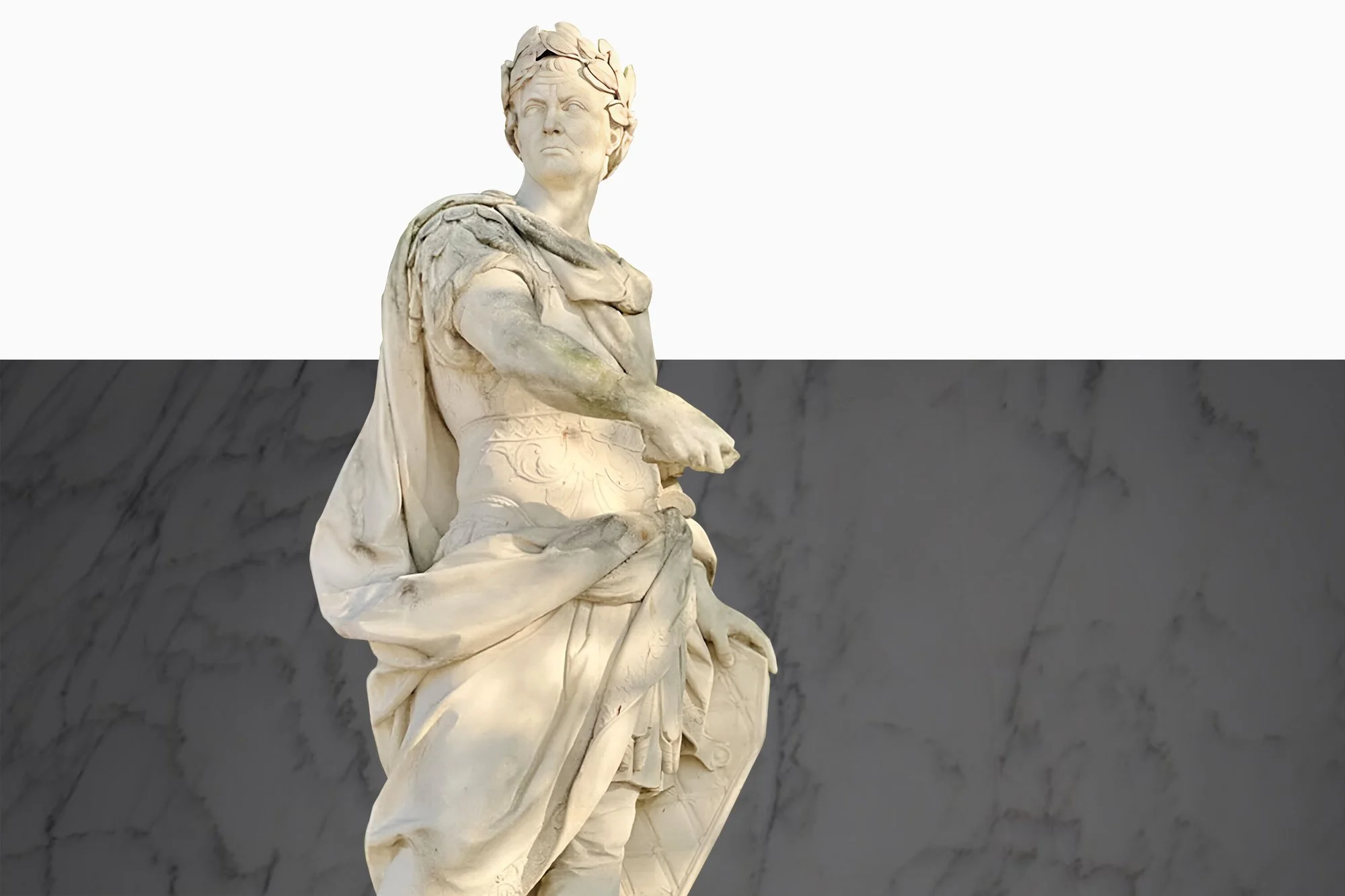 A marble statue of a woman with crossed arms and a confident expression, wearing a flowing toga, against a background divided into a white upper half and a dark marble-textured lower half, at Valor Monuments.