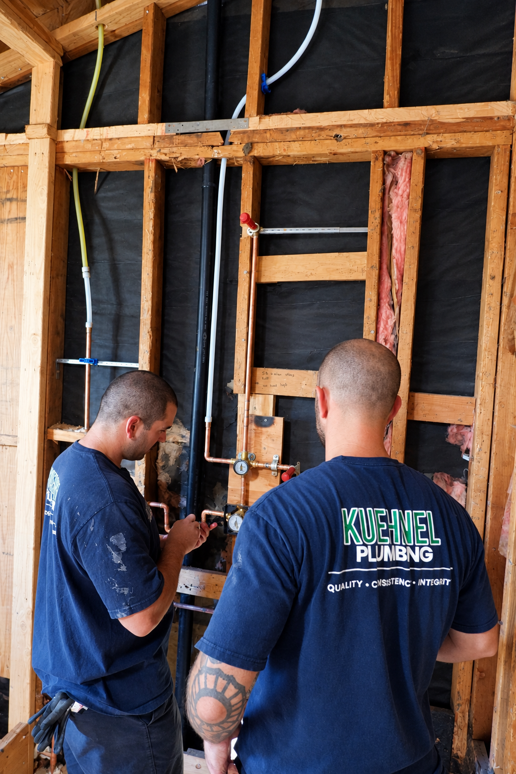 aKuehnel Plumbing crew installing copper water lines in an open wall at a remodel