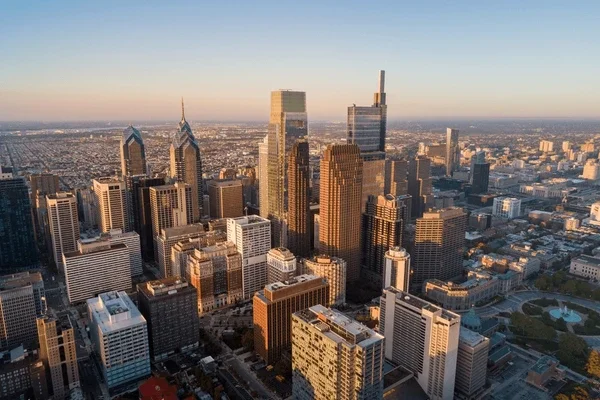 Aerial view of downtown Philadelphia skyscrapers at sunset.