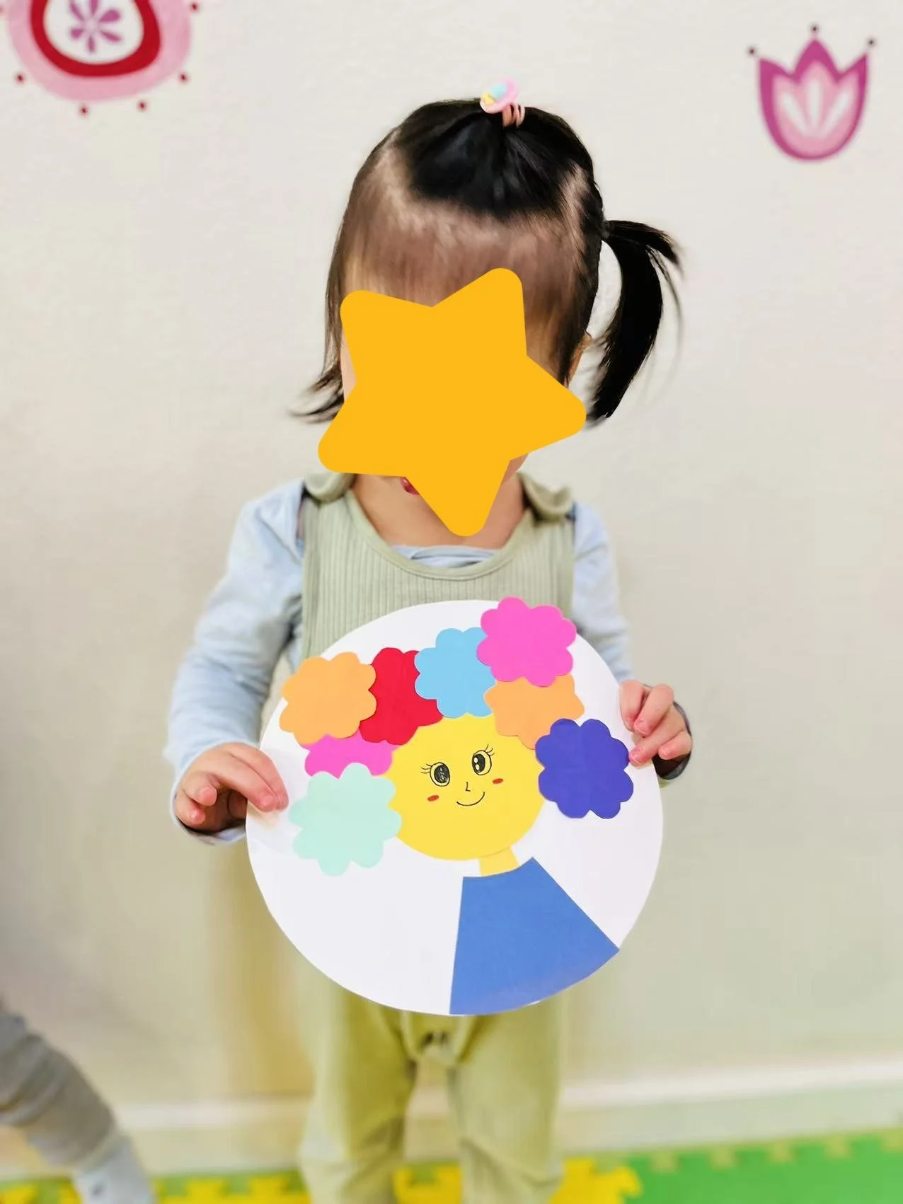 Child sharing an art project at Red Apple Daycare, encouraging creativity and confidence through self-expression.
