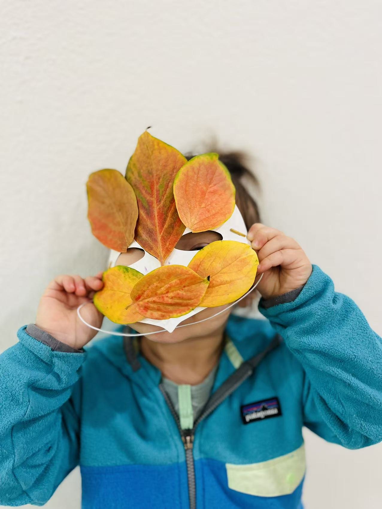 Child participating in a fall-themed art activity at Red Apple Daycare, exploring colors and seasonal creativity.
