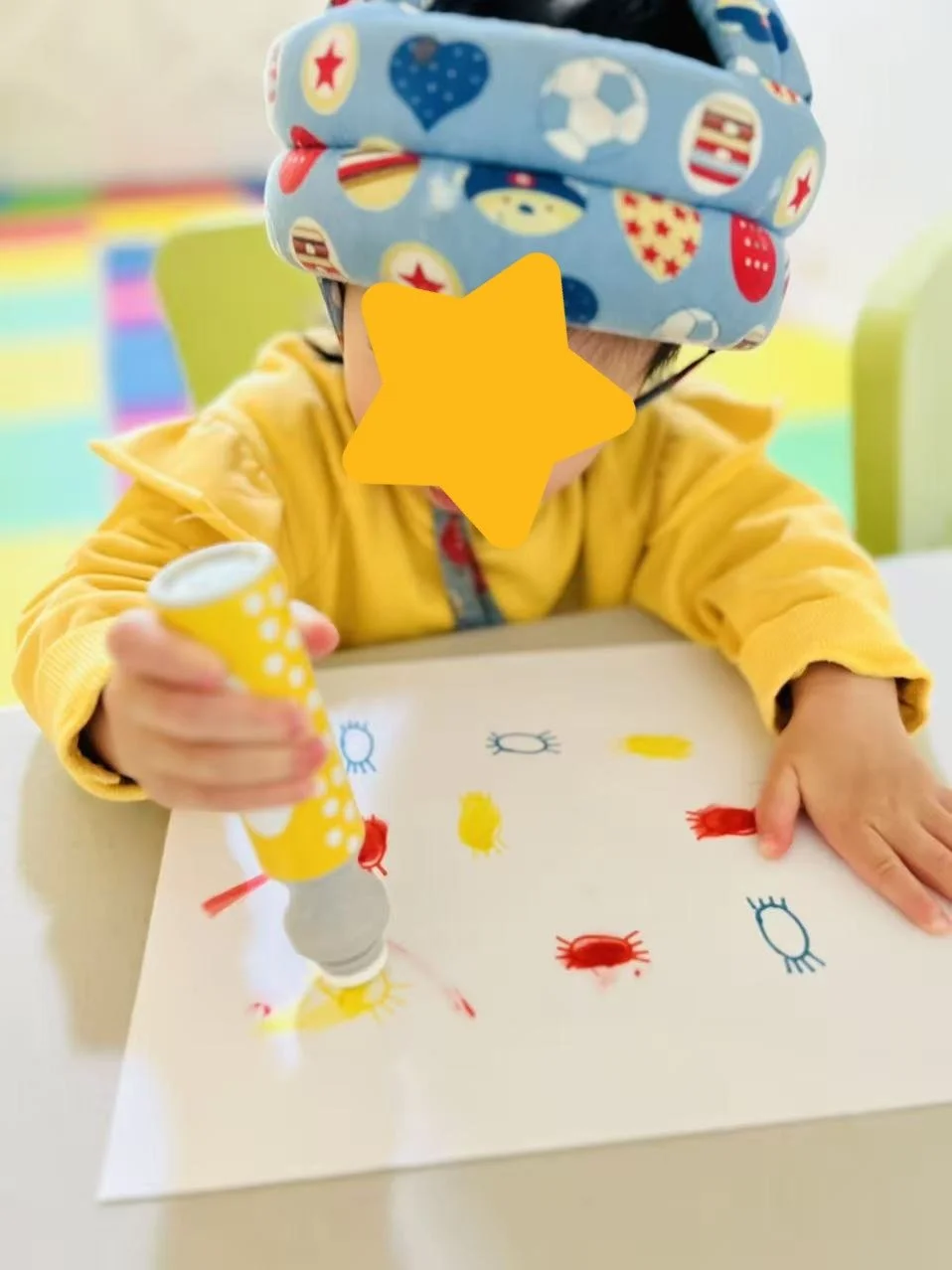 Child working on an art project at Red Apple Daycare, developing fine motor skills and creativity through hands-on activities.