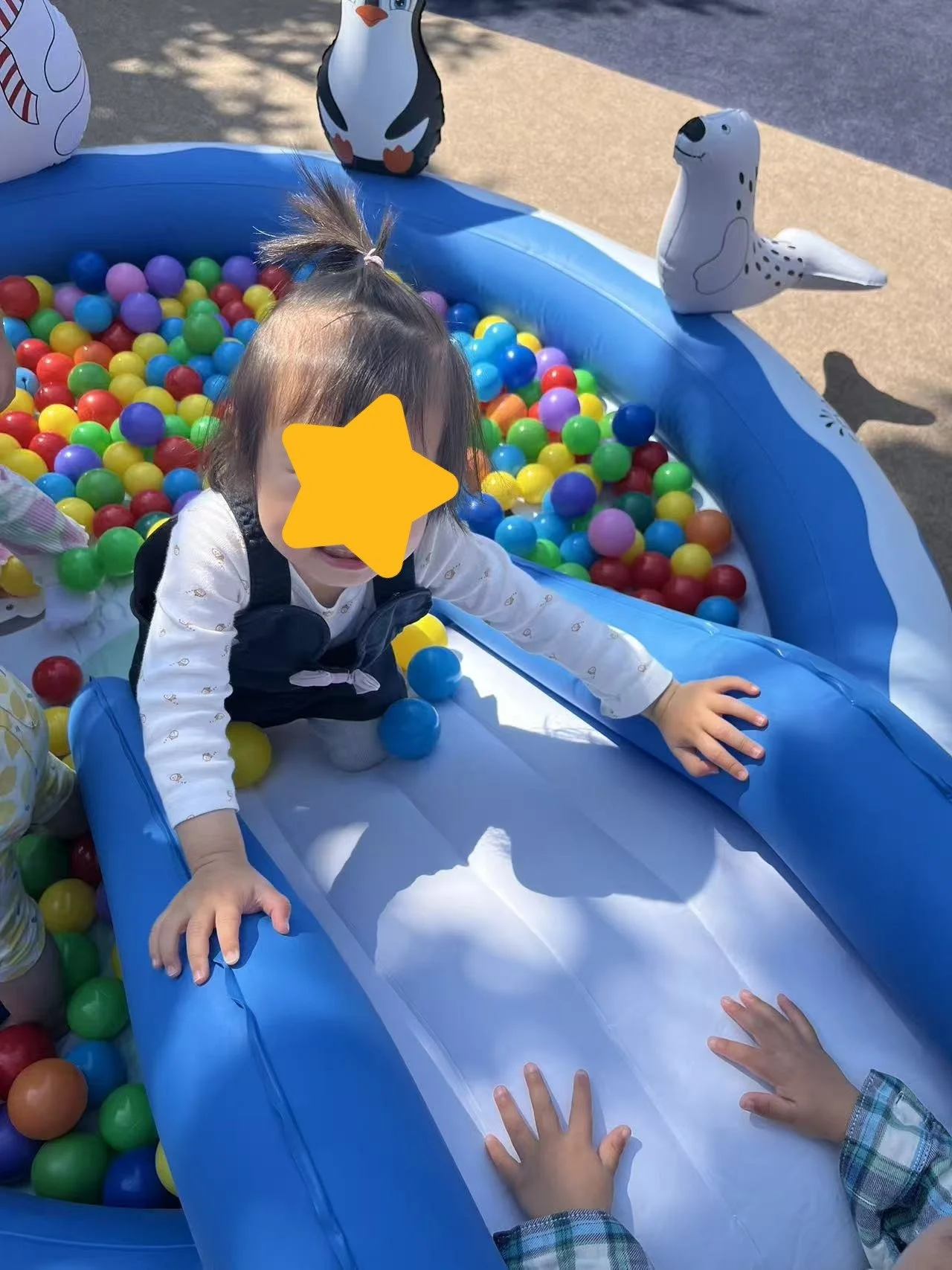 Child enjoying outdoor sensory play at Red Apple Daycare, supporting physical activity and sensory exploration.
