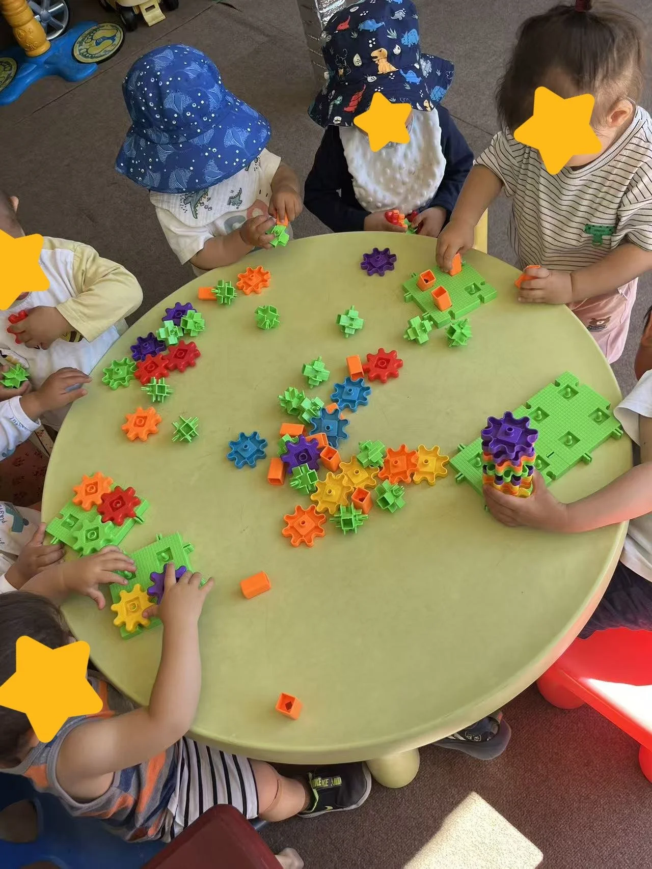 Children working with building toys at Red Apple Daycare, developing fine motor skills and problem-solving abilities.
