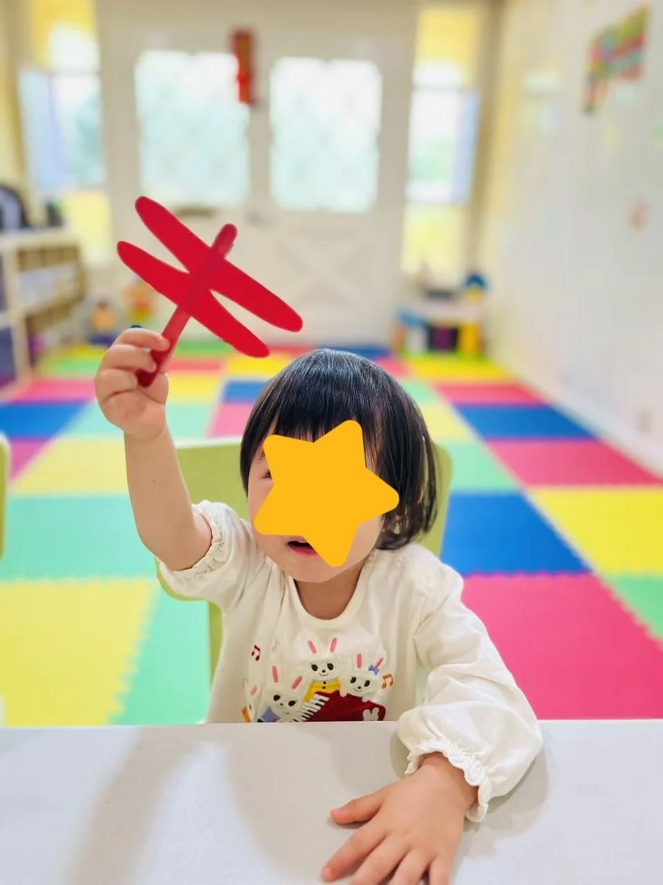 Child working with craft materials at Red Apple Daycare, supporting focus, creativity, and hands-on learning.
