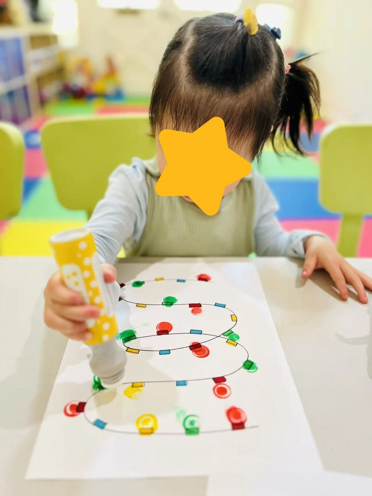 Child engaging in tabletop learning activities at Red Apple Daycare, supporting focus and fine motor skill development.
