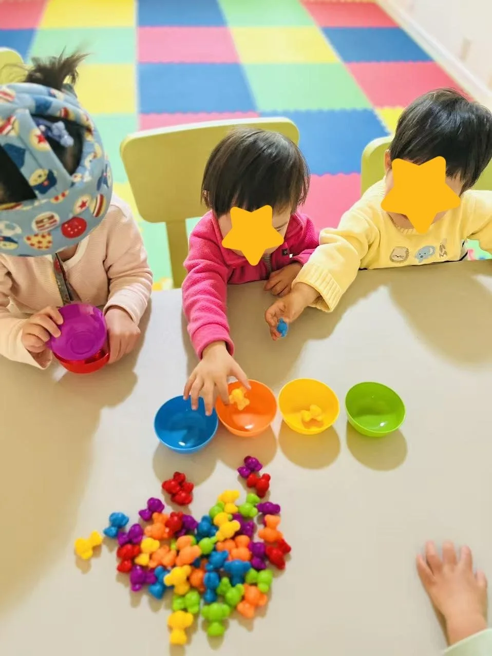 Children working with counting and sorting toys at Red Apple Daycare, supporting early math and cognitive skills.
