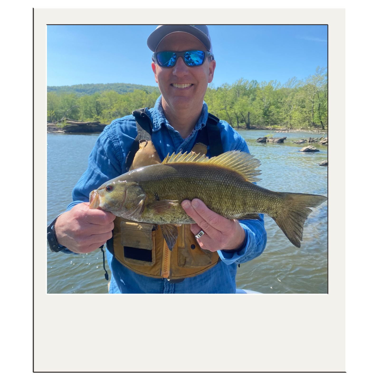 Angler displaying bass caught on a guided river fishing trip with White Fly Outfitters in northeast West Virginia.