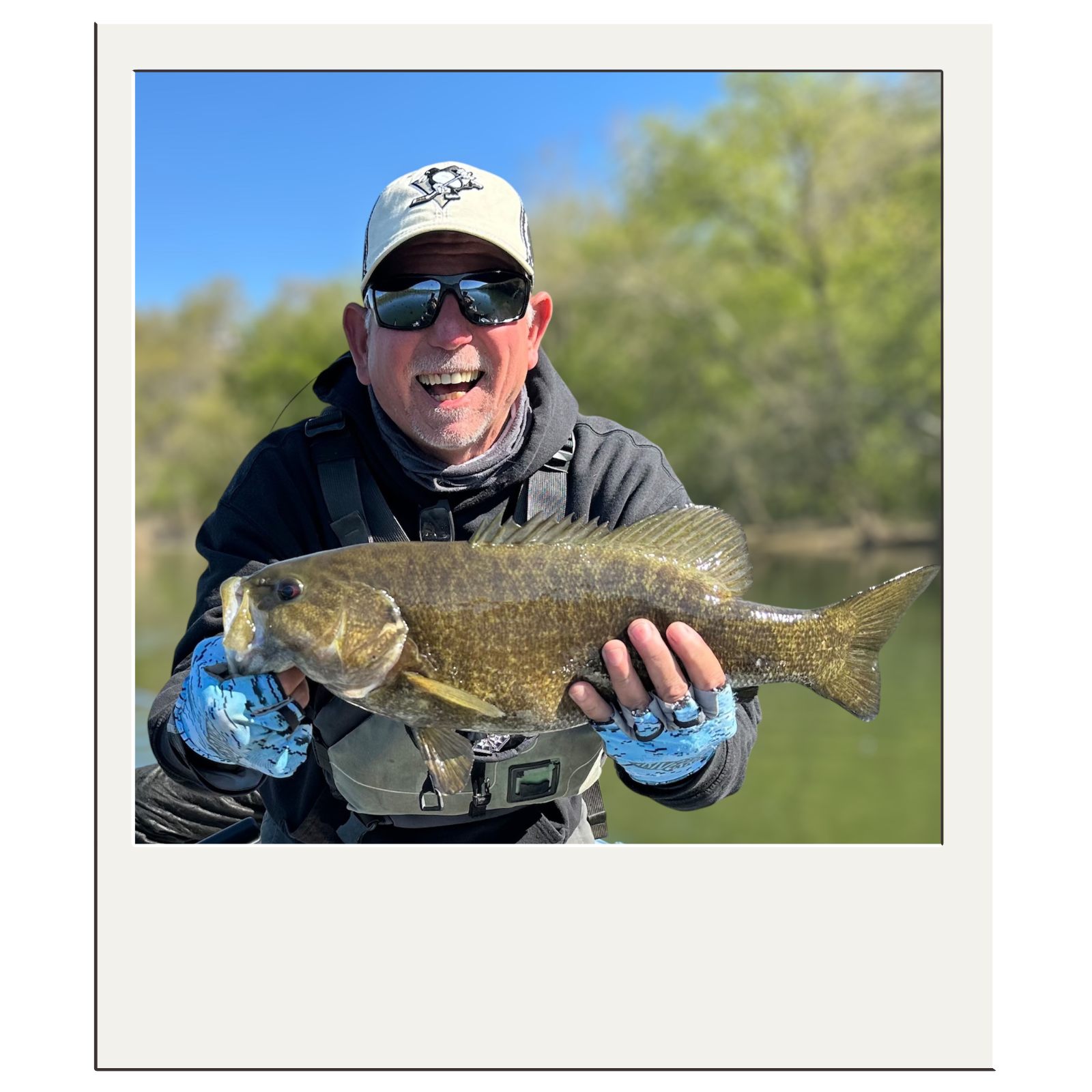 Bryan Kelly showing off catch-and-release smallmouth bass from a White Fly Outfitters guided trip.