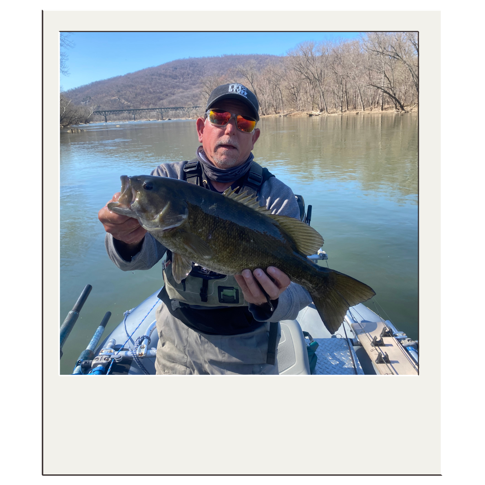 Guided fishing with Bryan Kelly holding a smallmouth bass caught on fly near the confluence of the Shenandoah and Potomac Rivers.
