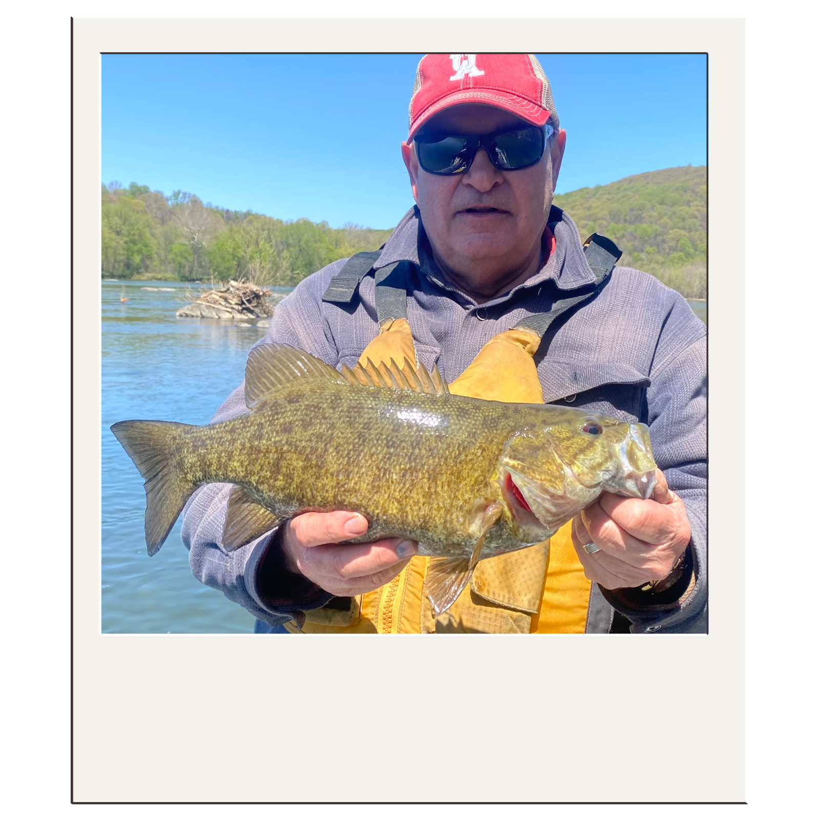 Angler with trophy bass caught on fly during a White Fly Outfitters river float in northeast West Virginia.