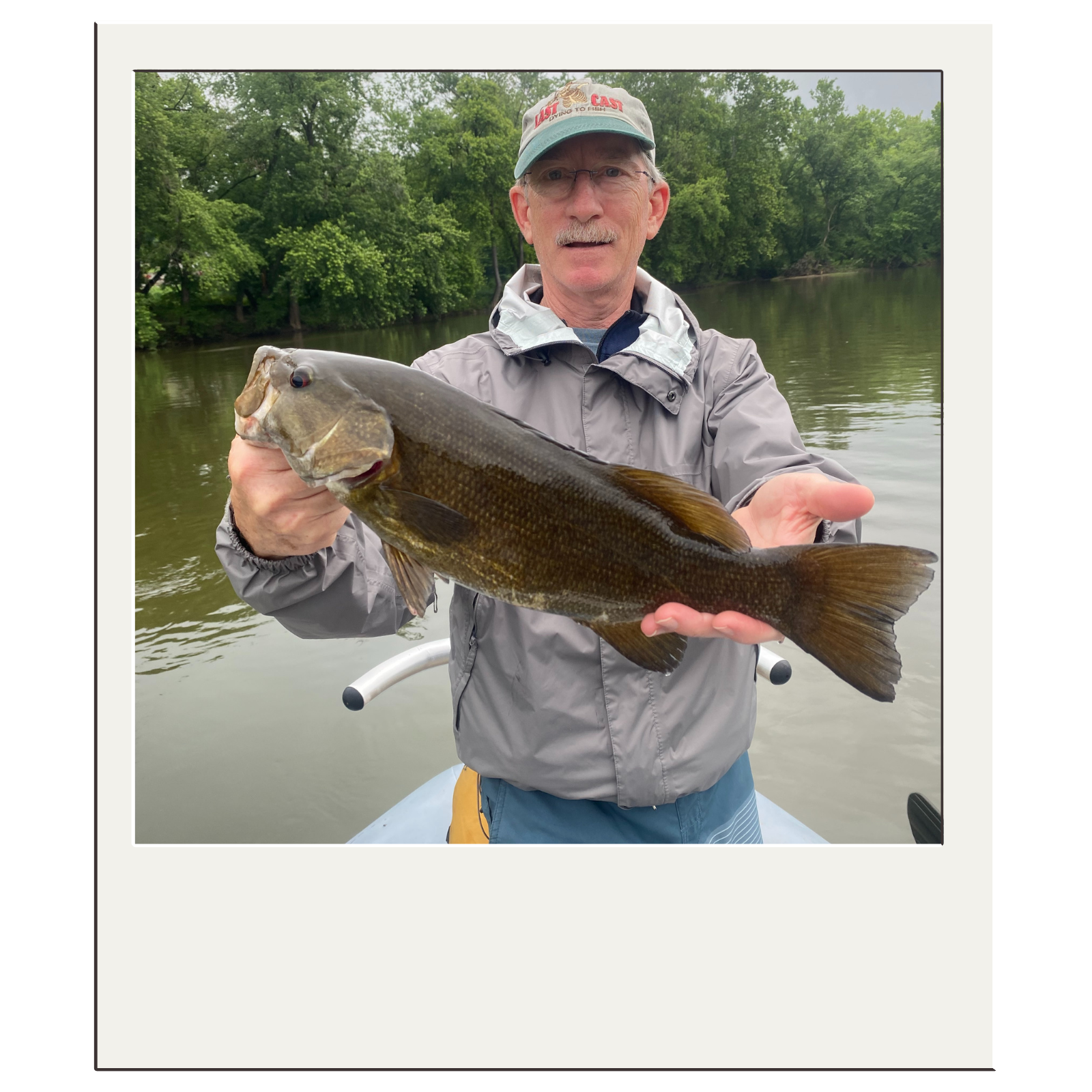 Angler proudly holding a smallmouth bass from a guided fly-fishing trip near Harpers Ferry, WV.