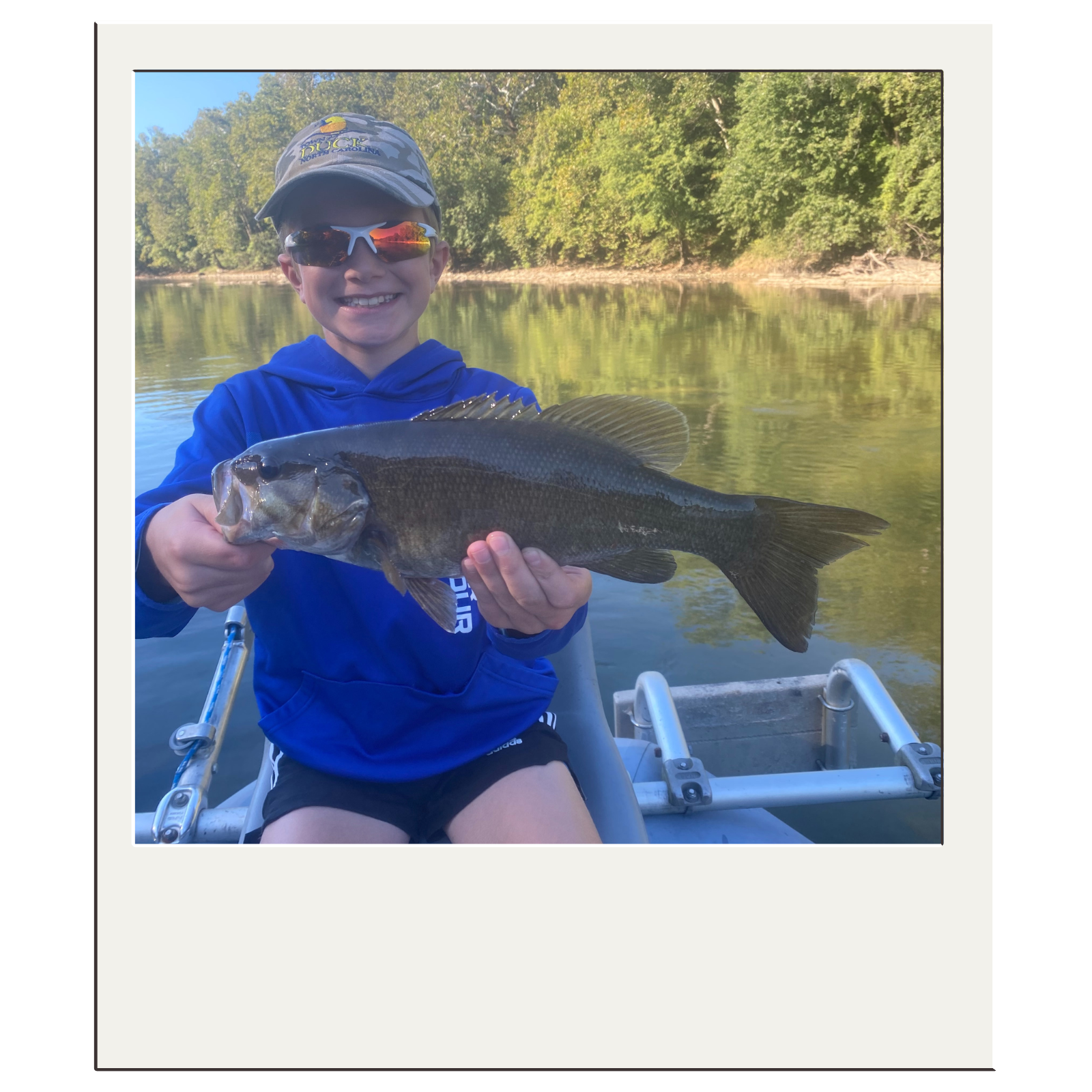 Smiling fly-fisherman displaying smallmouth bass from a White Fly Outfitters trip near Harpers Ferry.