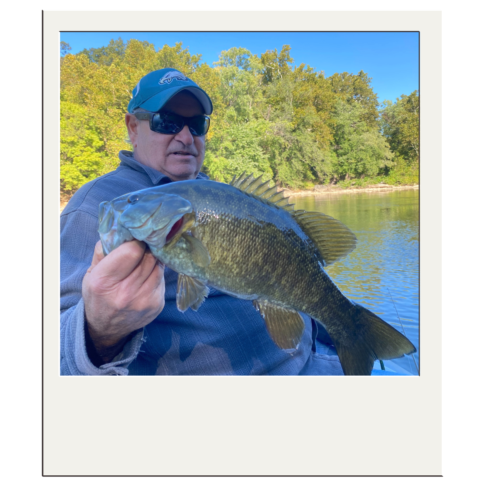 Fly-fishing client with bass caught on a fall morning near Harpers Ferry, West Virginia.