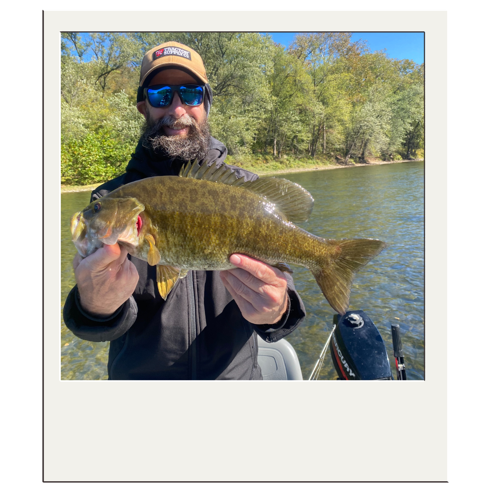 Fly-fishing client holding a smallmouth bass caught on a guided river trip near Harpers Ferry, WV.