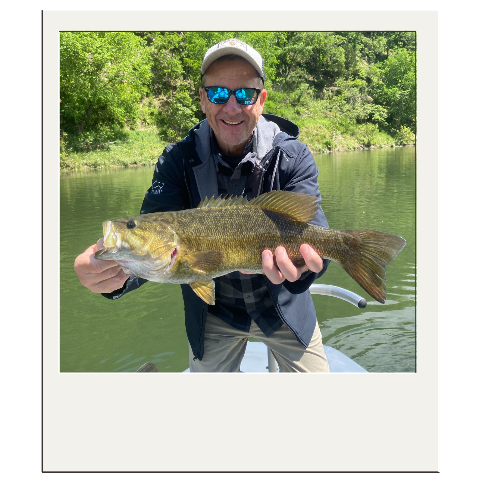 Guided fishing trip client holding a bass along the Potomac River near Harpers Ferry, WV.