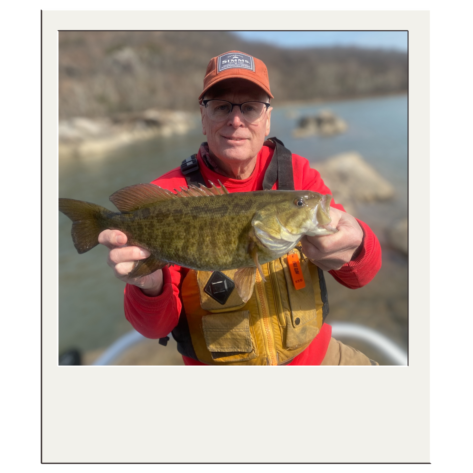 Fisherman proudly displaying bass caught on a fly rod with White Fly Outfitters in Harpers Ferry, WV.