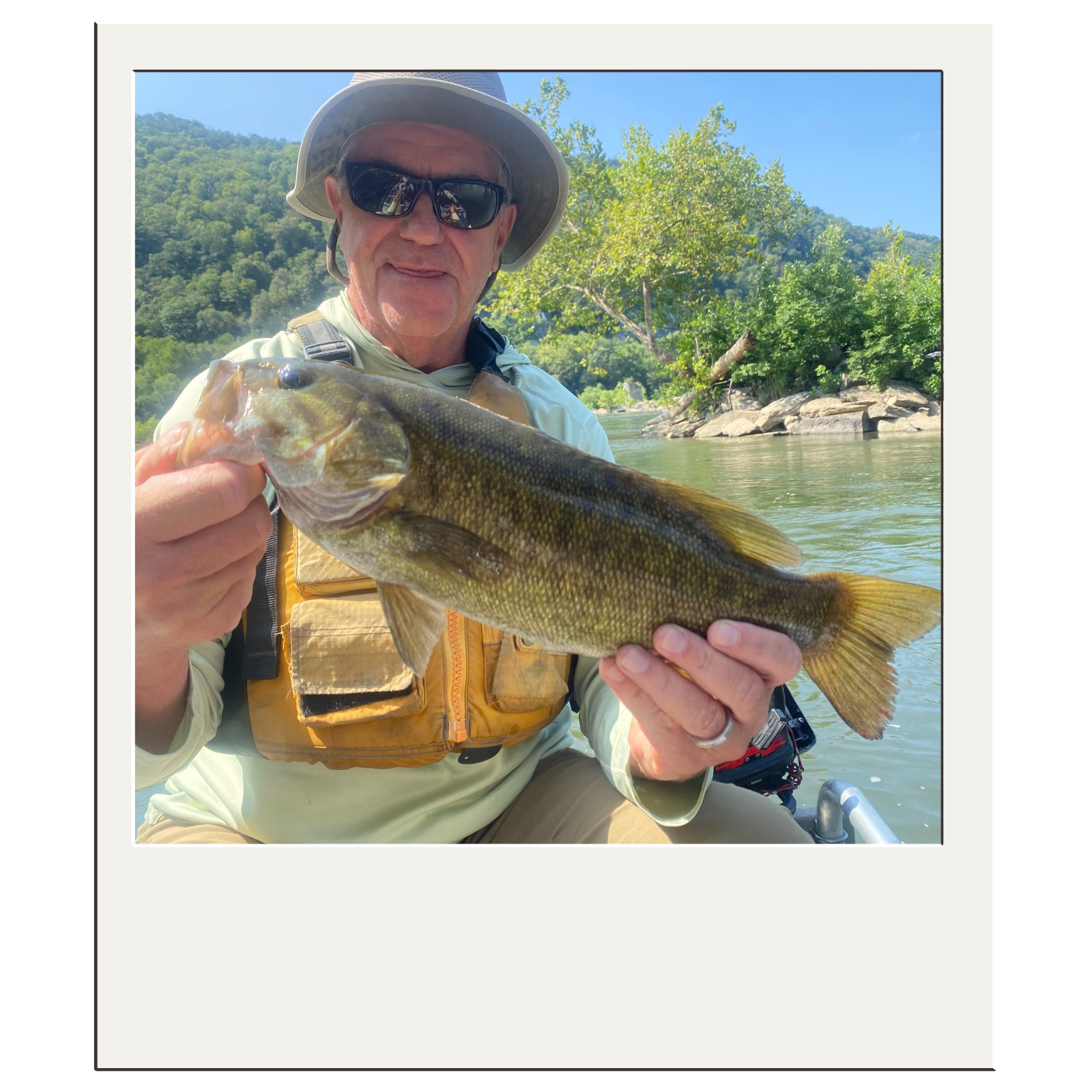 Fisherman displaying trophy-sized smallmouth bass caught on the Potomac River.