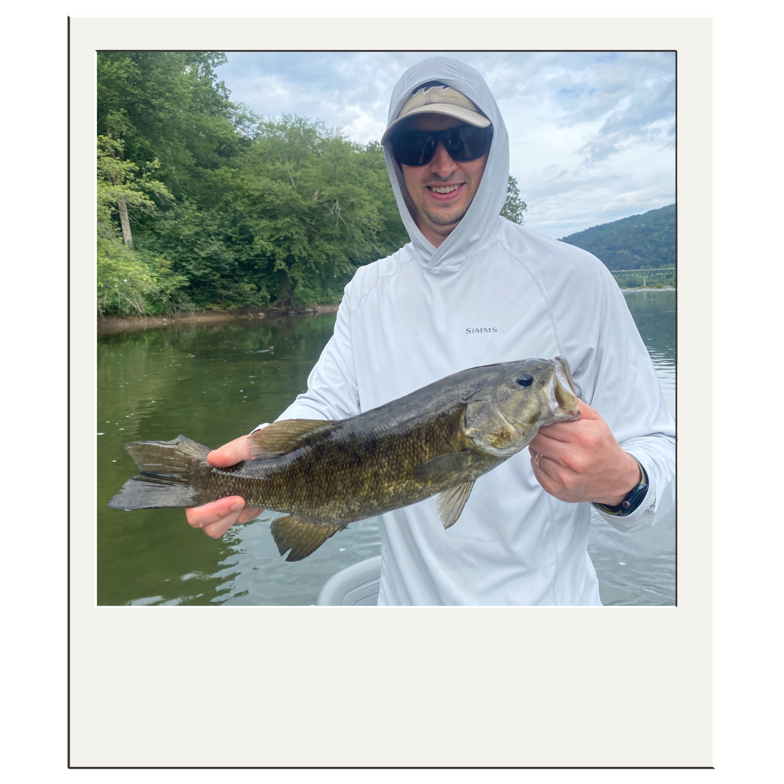 Smiling client after landing a strong bass during a guided Harpers Ferry fly-fishing trip.