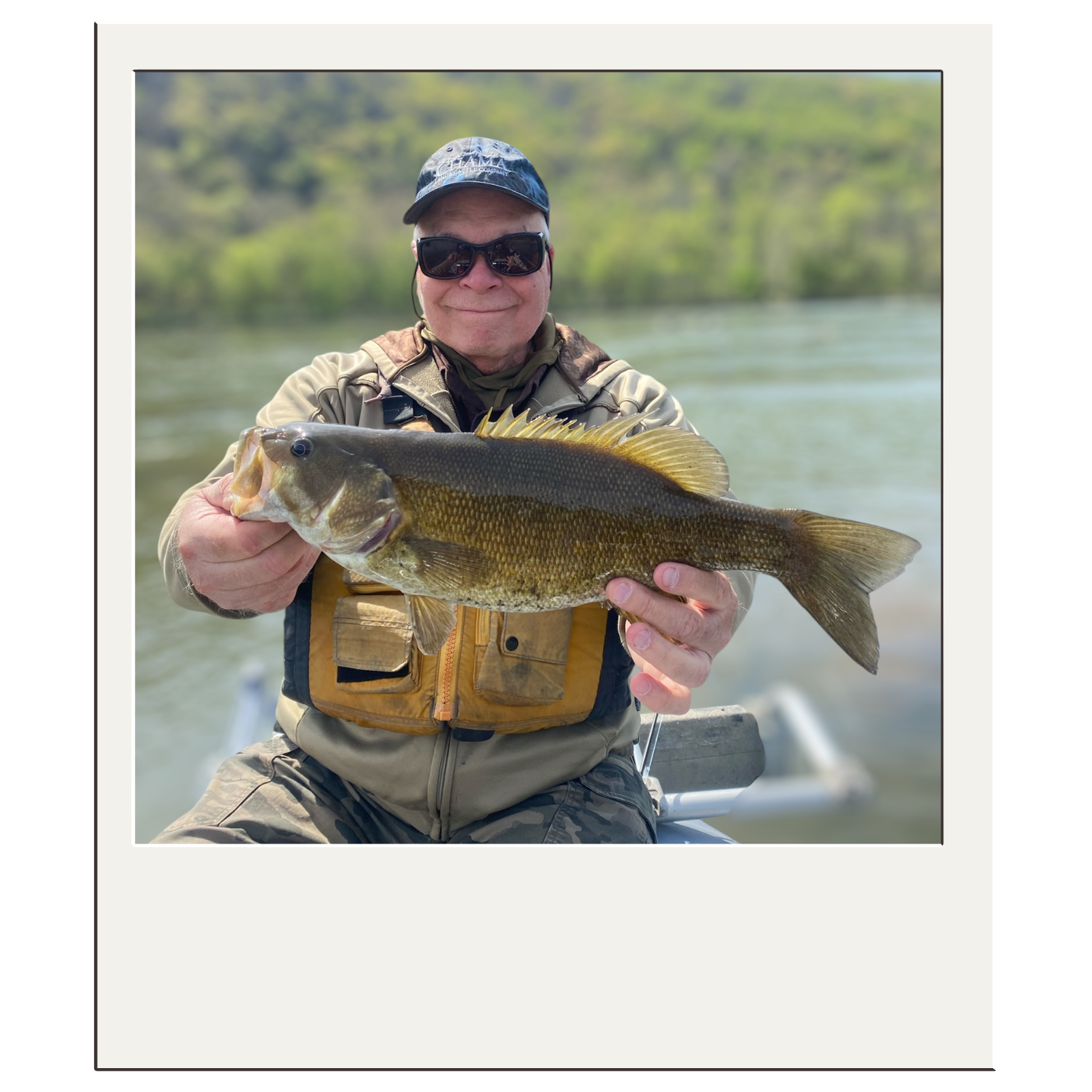 Angler proudly displaying bass from a guided Potomac River trip with White Fly Outfitters.