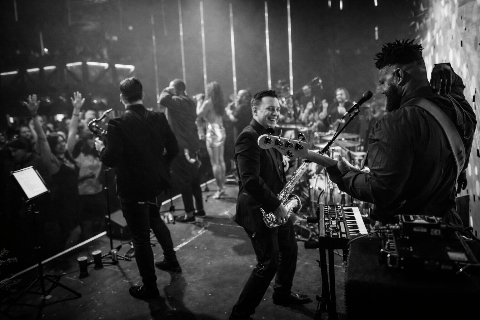 Bass player and sax player enjoying a moment on stage