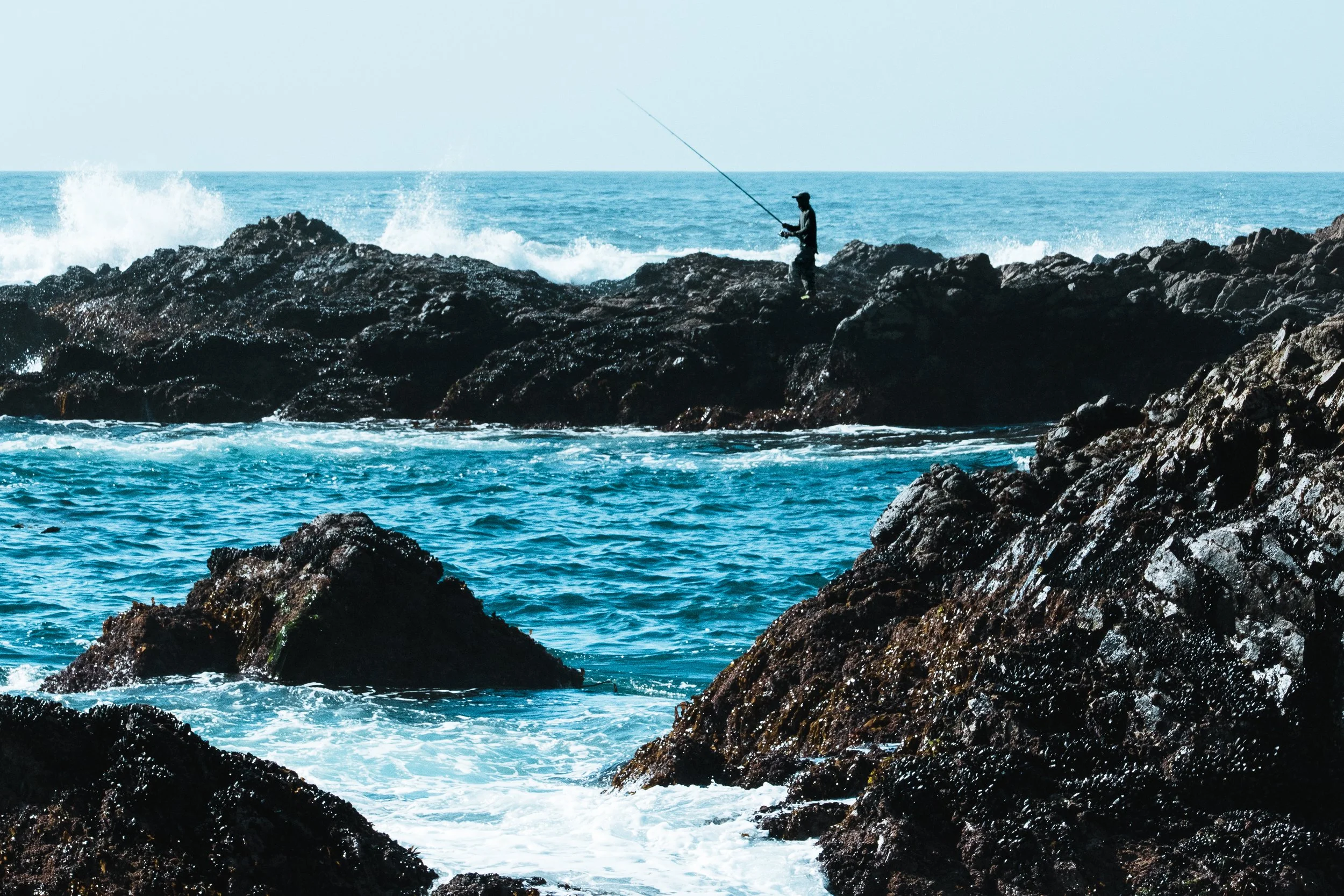Fisherman On The Rocks