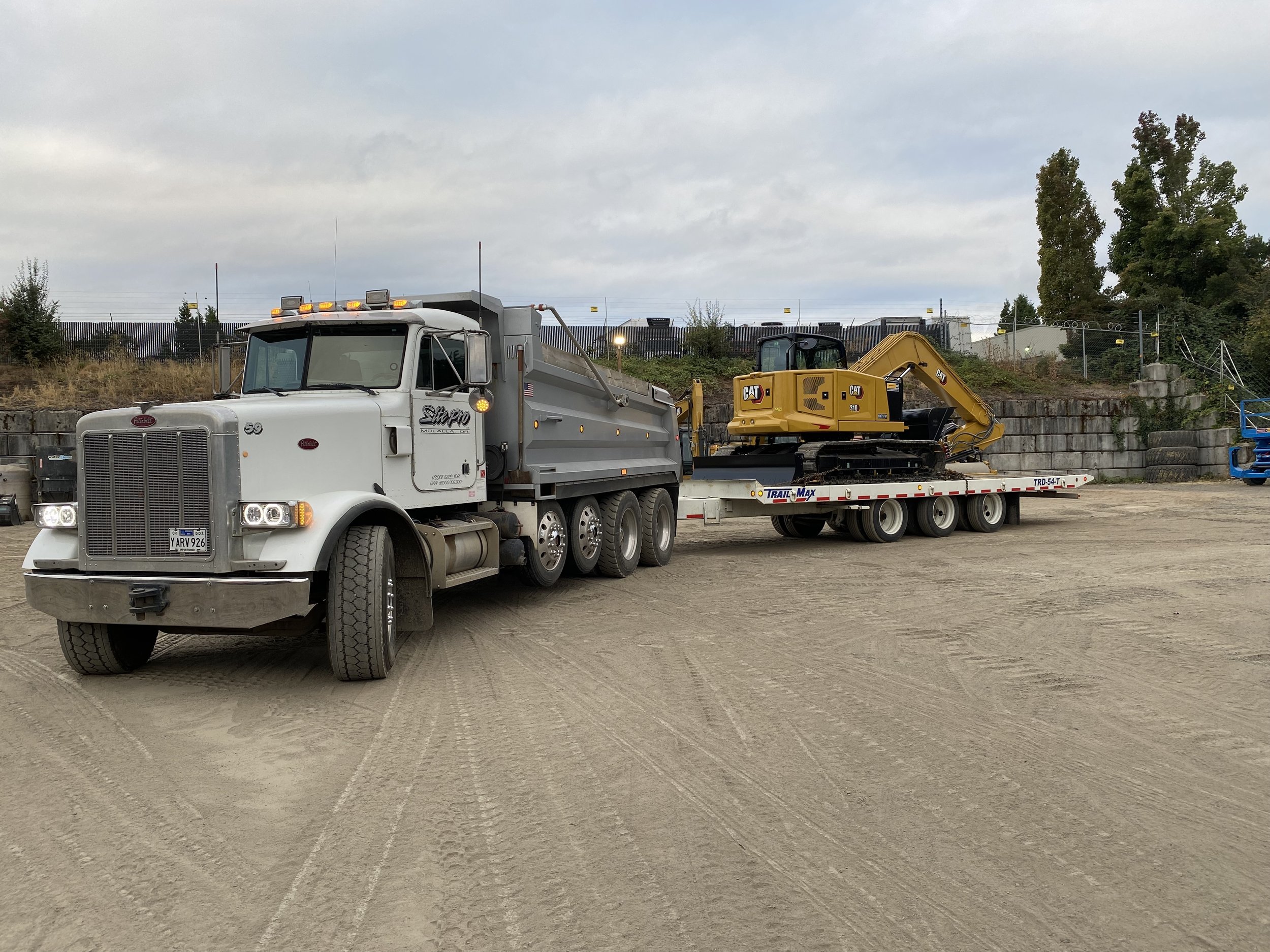 Site Pro LLC dump trucking, hauling heavy equipment, importing and exporting job site materials and hauling asphault.