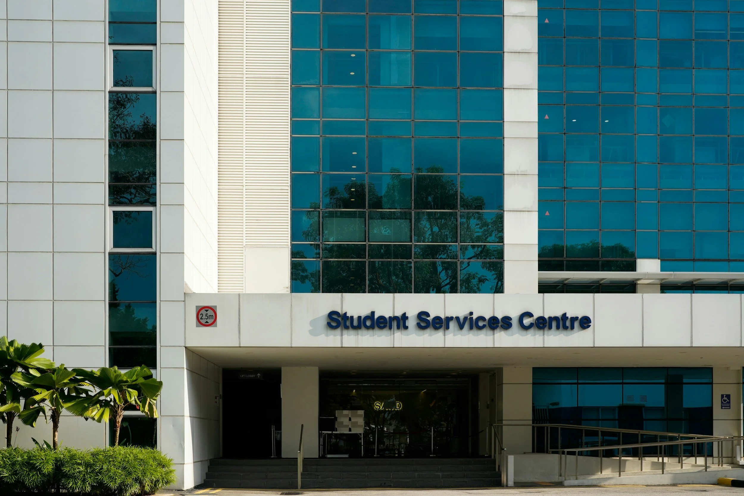 Student services on school building sign white building with tinted glass