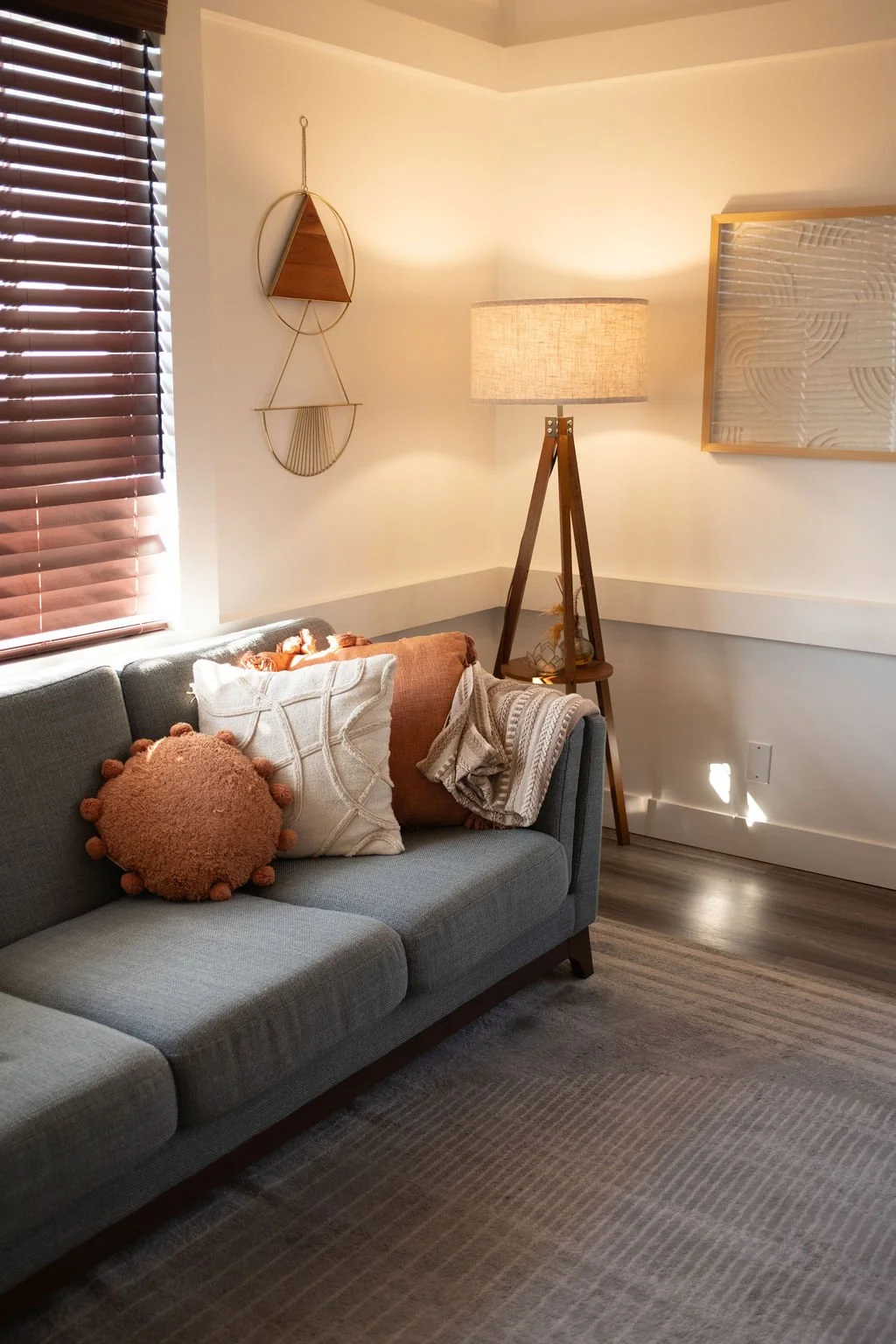 Warm individual therapy office with a sofa and floor lamp at Forbes Individual and Family Therapy in Newport Beach