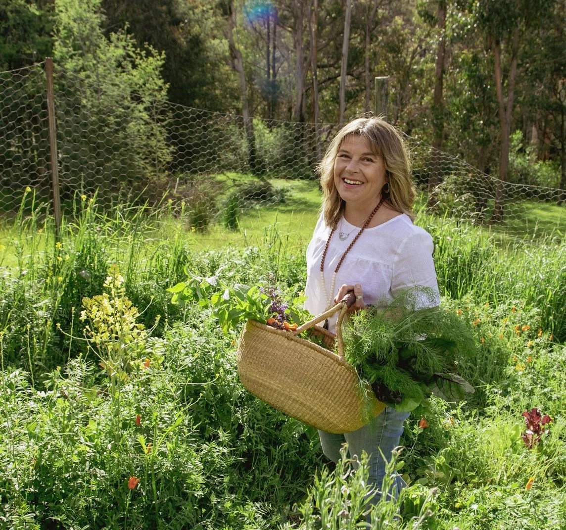 Kate Holman Naturopath with garden vegetables smiling in Tasmania | organic wellness, nutrition and holistic health lifestyle