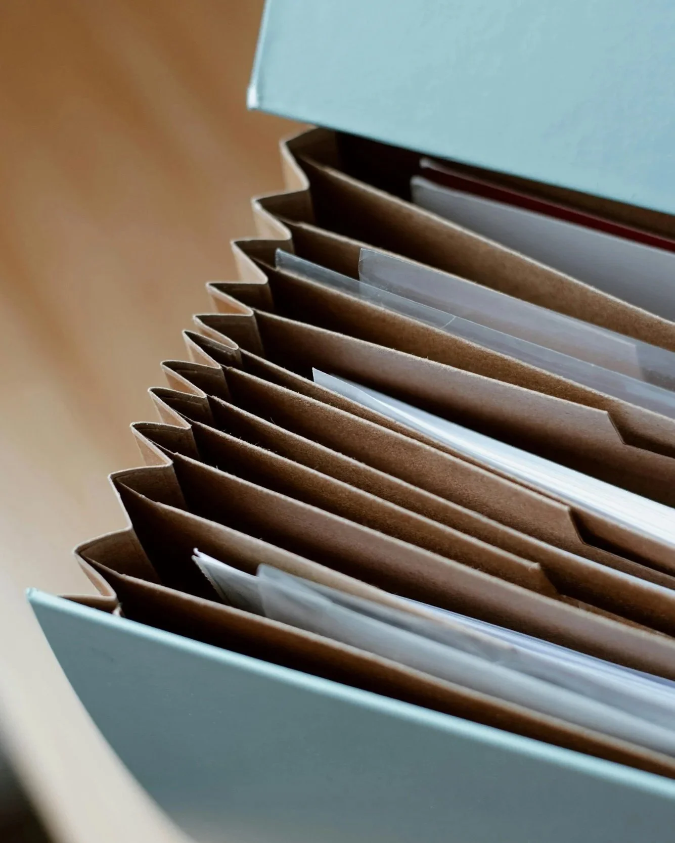 Close-up of a drawer filled with file folders and documents organized in a filing system.