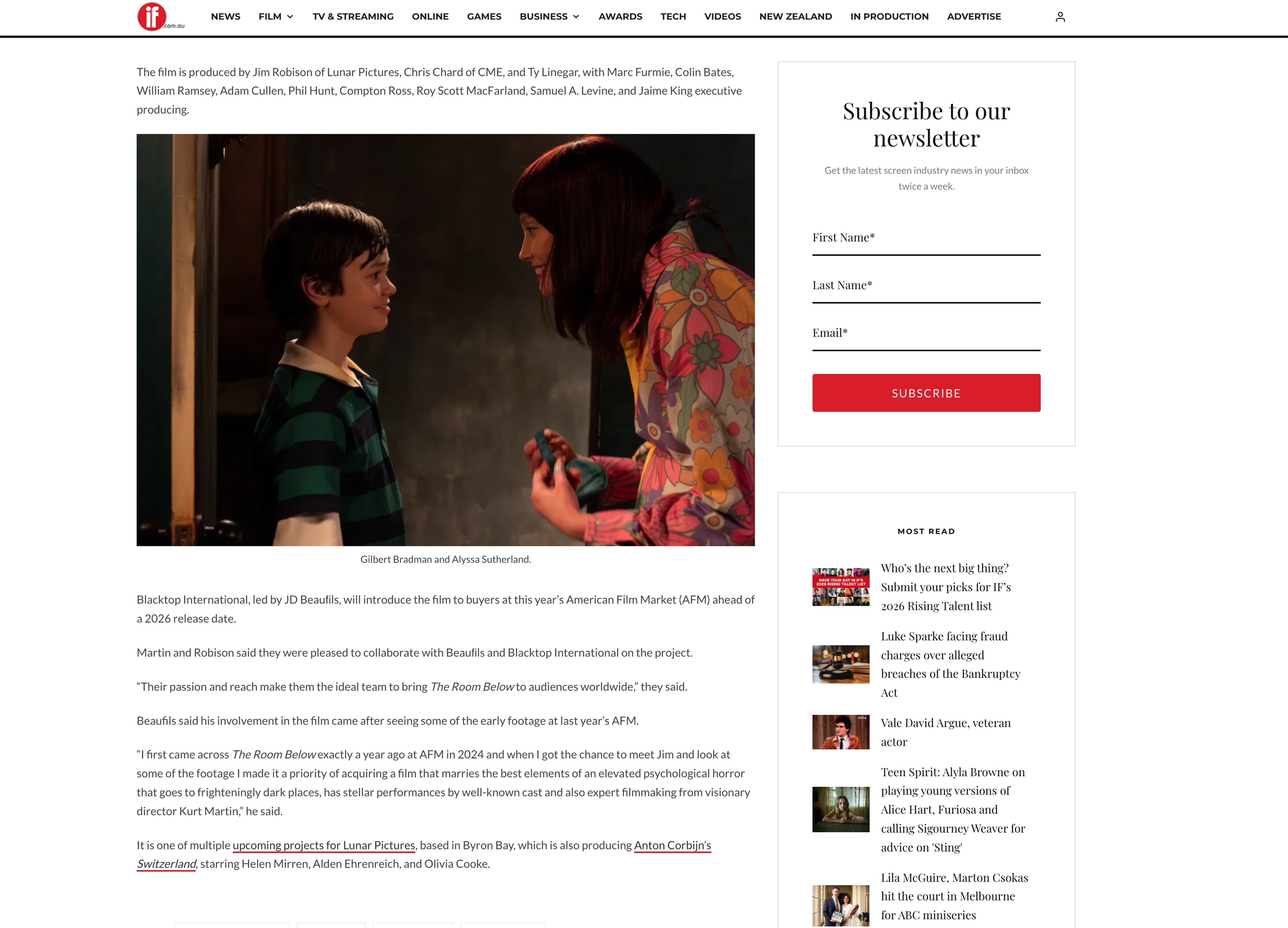 Gilbert Bradman and Alyssa Sutherland engaging in a conversation, with Alyssa smiling and holding an object in her hand.