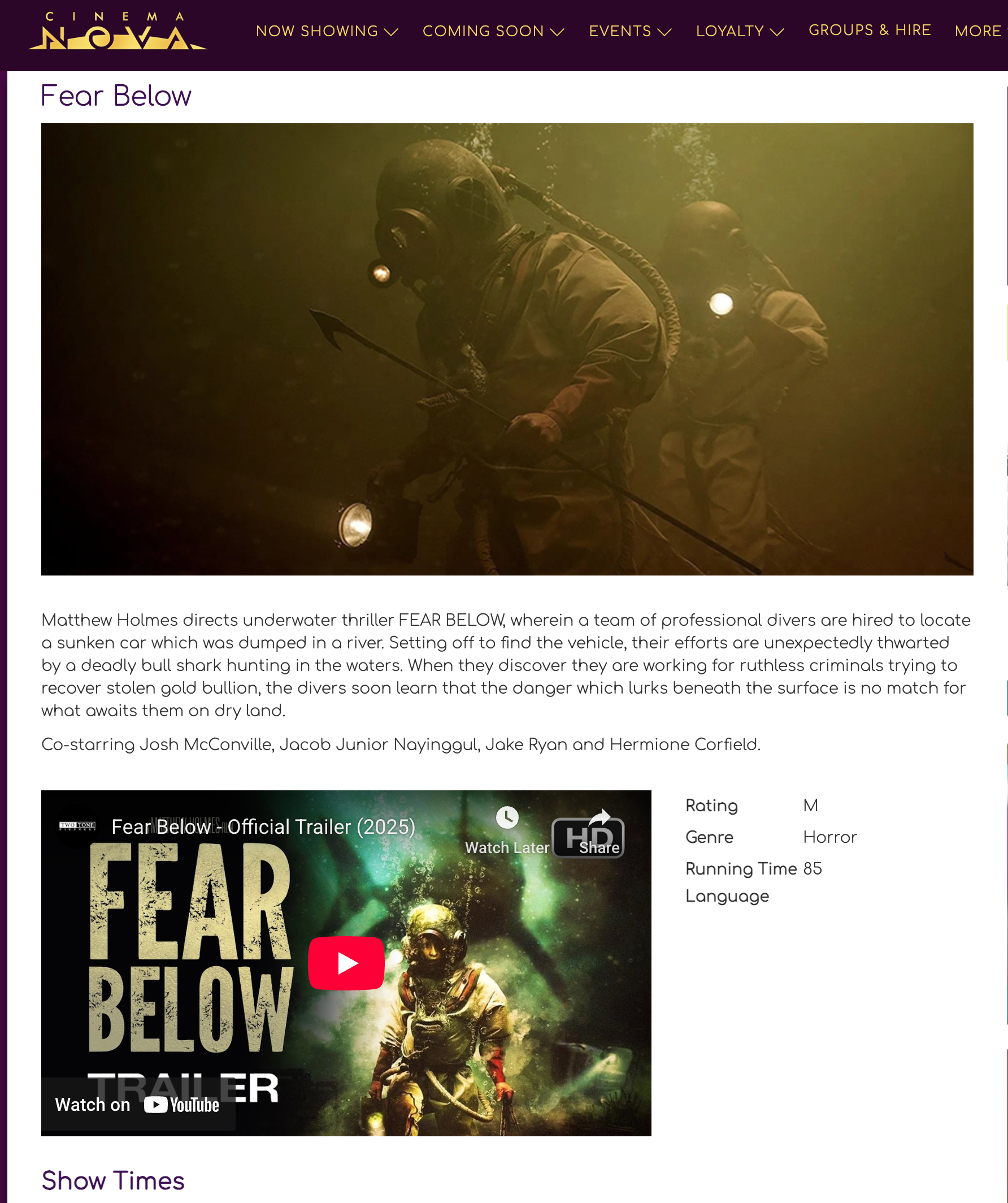 Two scuba divers underwater exploring a murky, greenish environment, wearing wetsuits and helmets with lights.