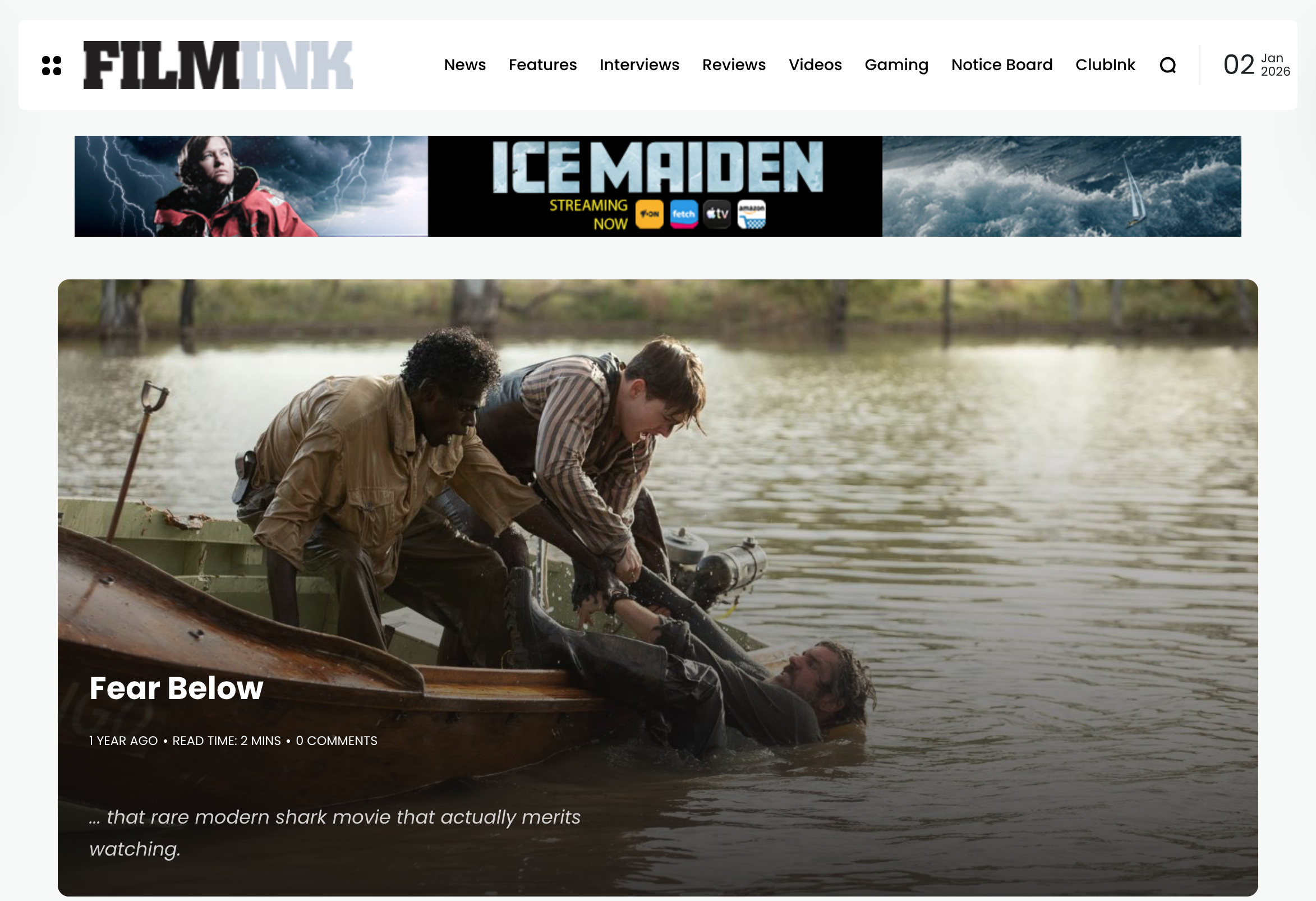 Scene from the movie 'Fear Below' showing three people at the edge of a body of water, two pulling a man out of the water in a boat, with trees in the background.