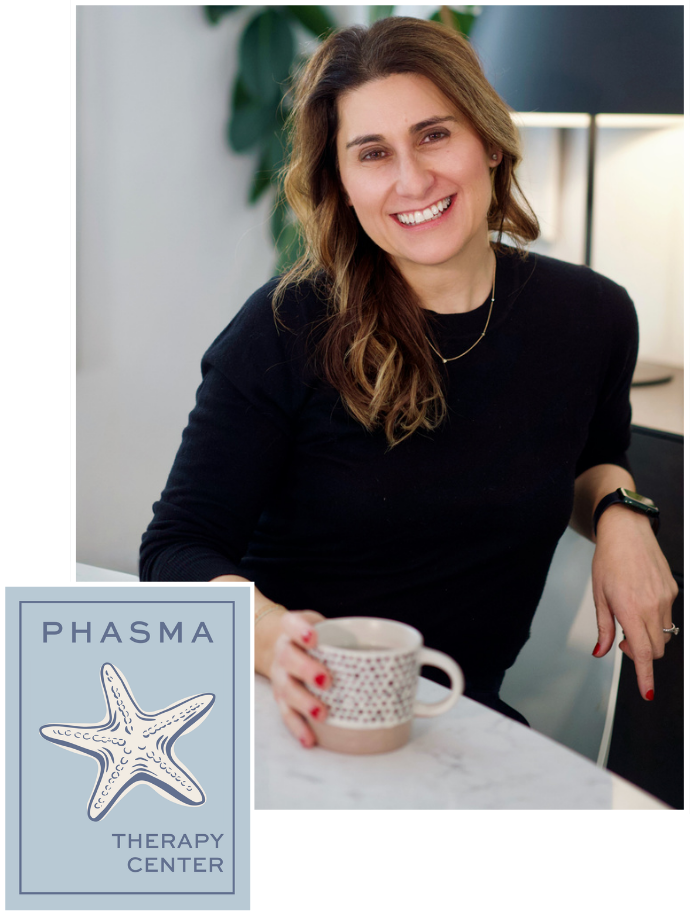 Smiling woman holding a patterned coffee mug, sitting at a table in a modern office or therapy center, with a logo for Phasma Therapy Center featuring a starfish in the bottom left corner.
