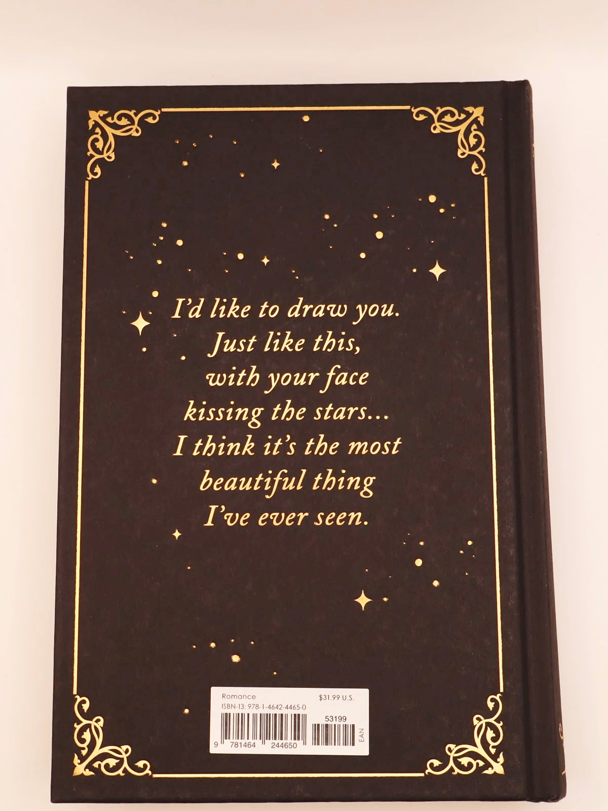 Black and gold back cover of Scarred by Emily McIntire with a romantic quote about "kissing the stars".