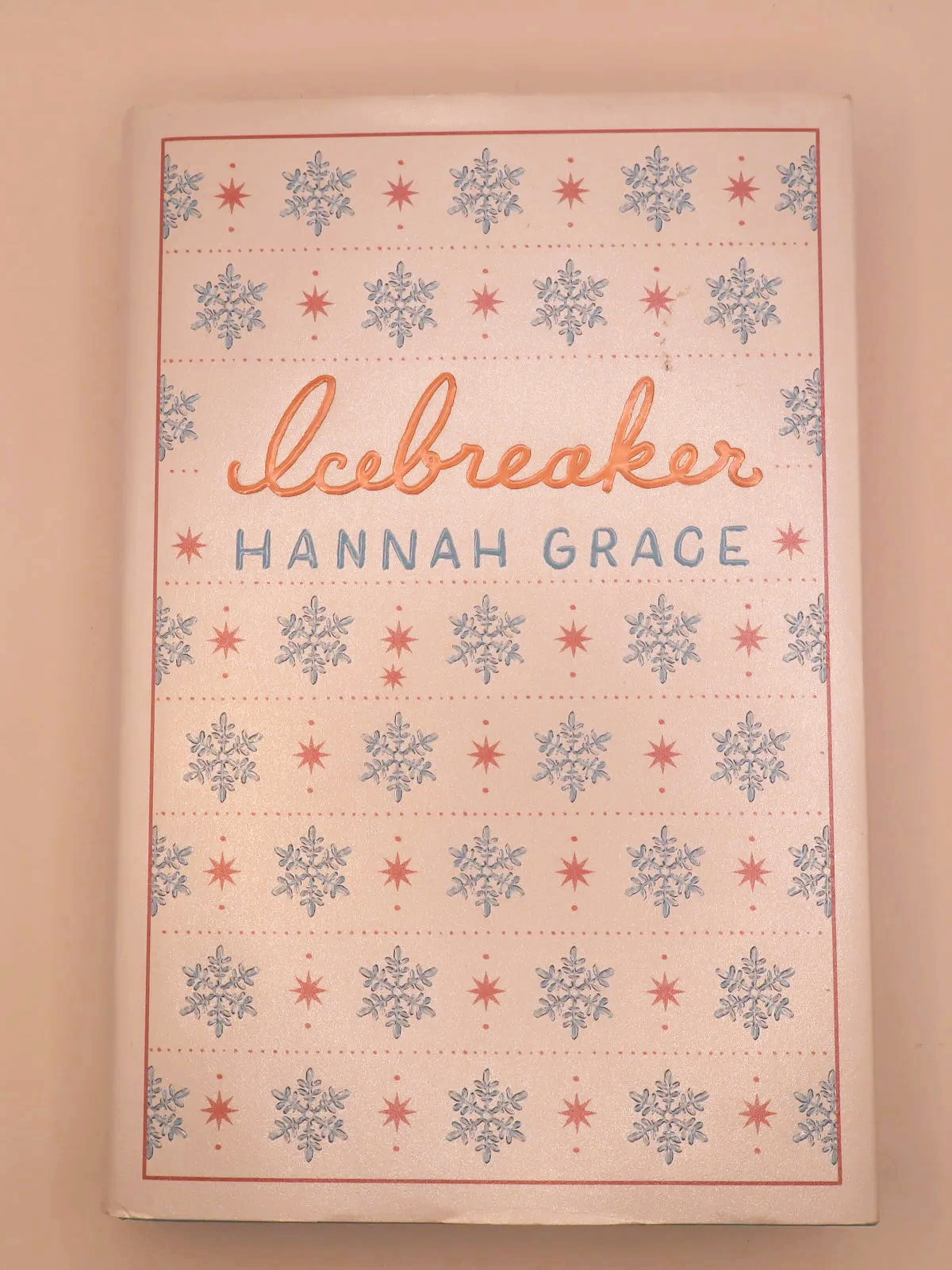 Front cover of Icebreaker by Hannah Grace, featuring a white background with blue and red snowflakes.