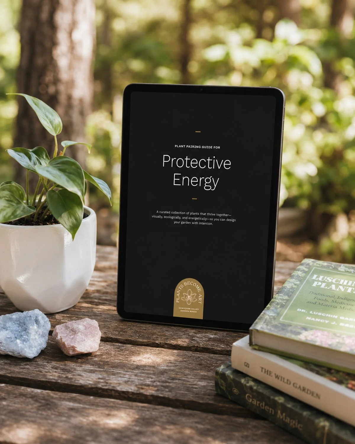 Mockup of the Plant Pairing Guide on a tablet, surrounded by crystals and horticulture books on a wooden table