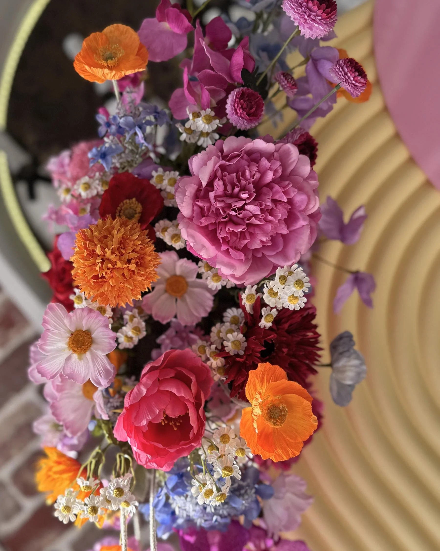 Vibrant celebration floral styling in Gold Coast featuring colourful seasonal blooms and statement backdrop design by Saudade Events.
