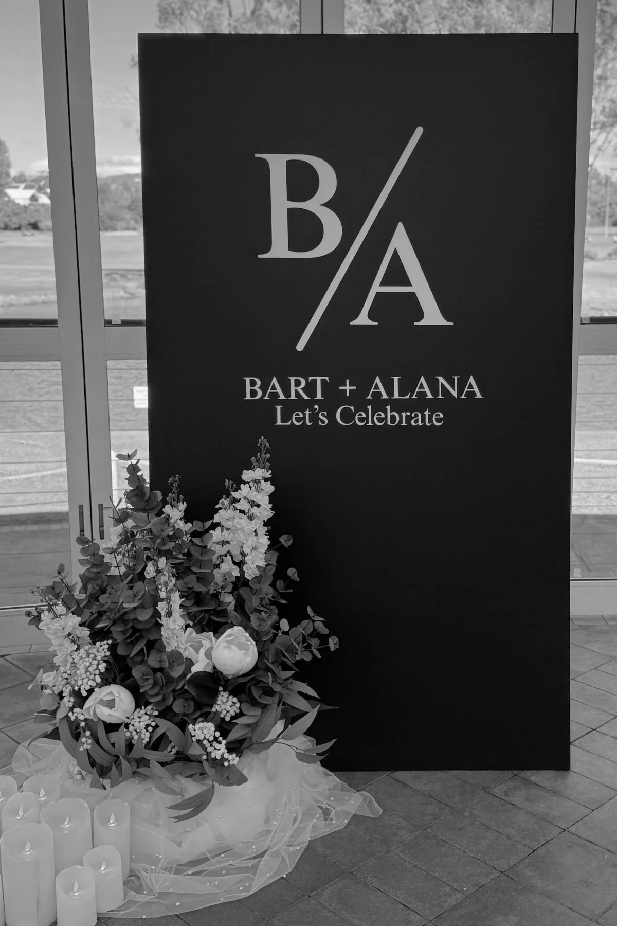 Gold Coast engagement styling featuring custom black welcome sign and white floral arrangement by Saudade Events.