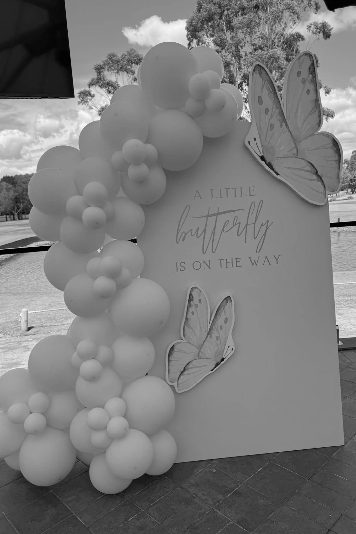 Pastel organic balloon garland with butterfly baby shower backdrop styled by Saudade Events on the Gold Coast.