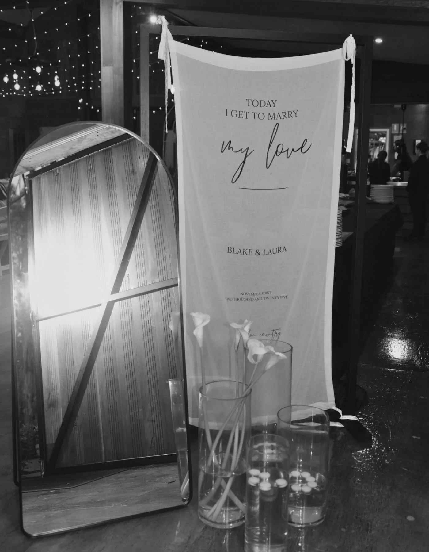 Custom wedding fabric signage and mirror styling detail with florals, designed by Saudade Events on the Gold Coast.