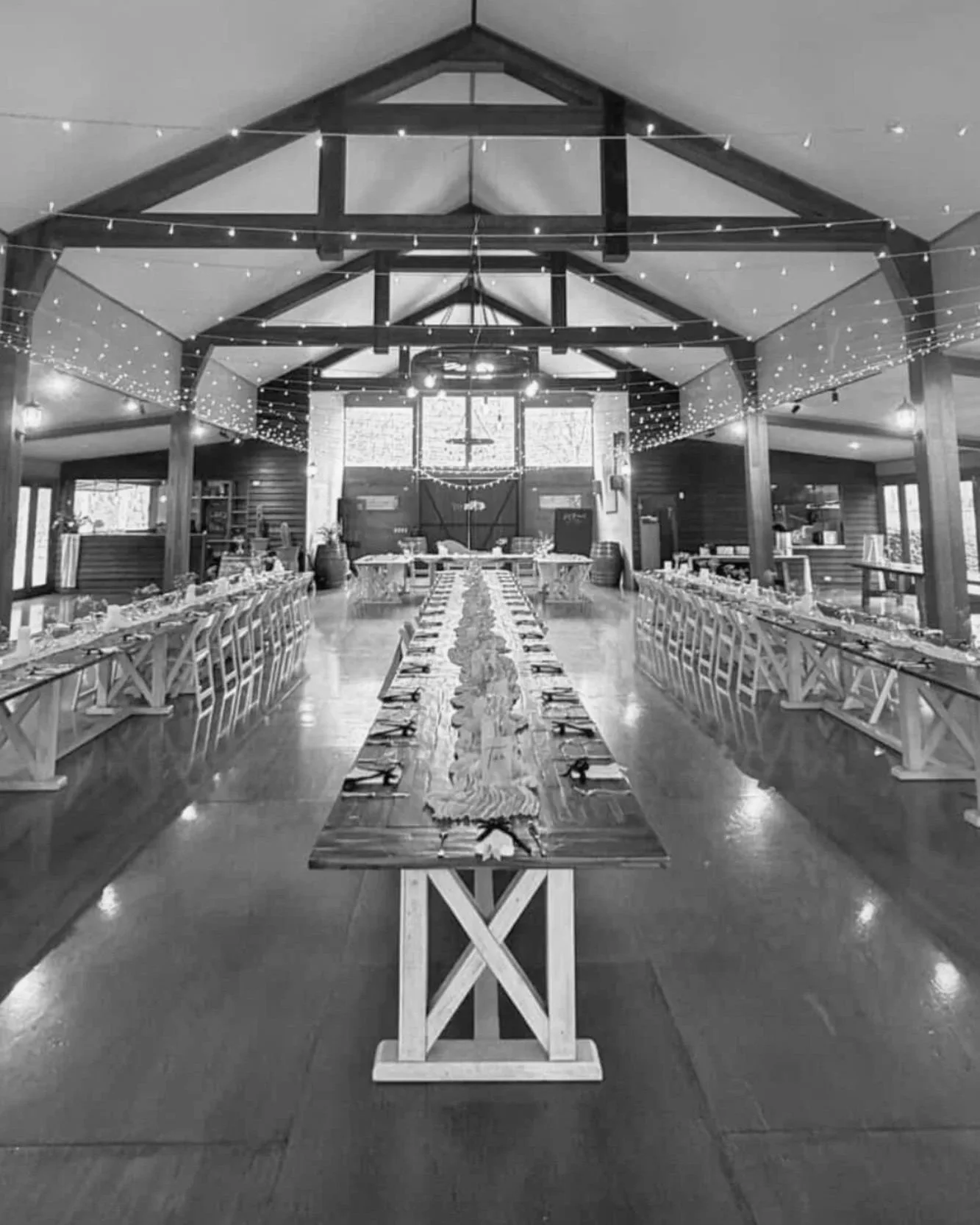 Wedding reception styling with long banquet tables and festoon lighting inside a rustic Gold Coast venue styled by Saudade Events.