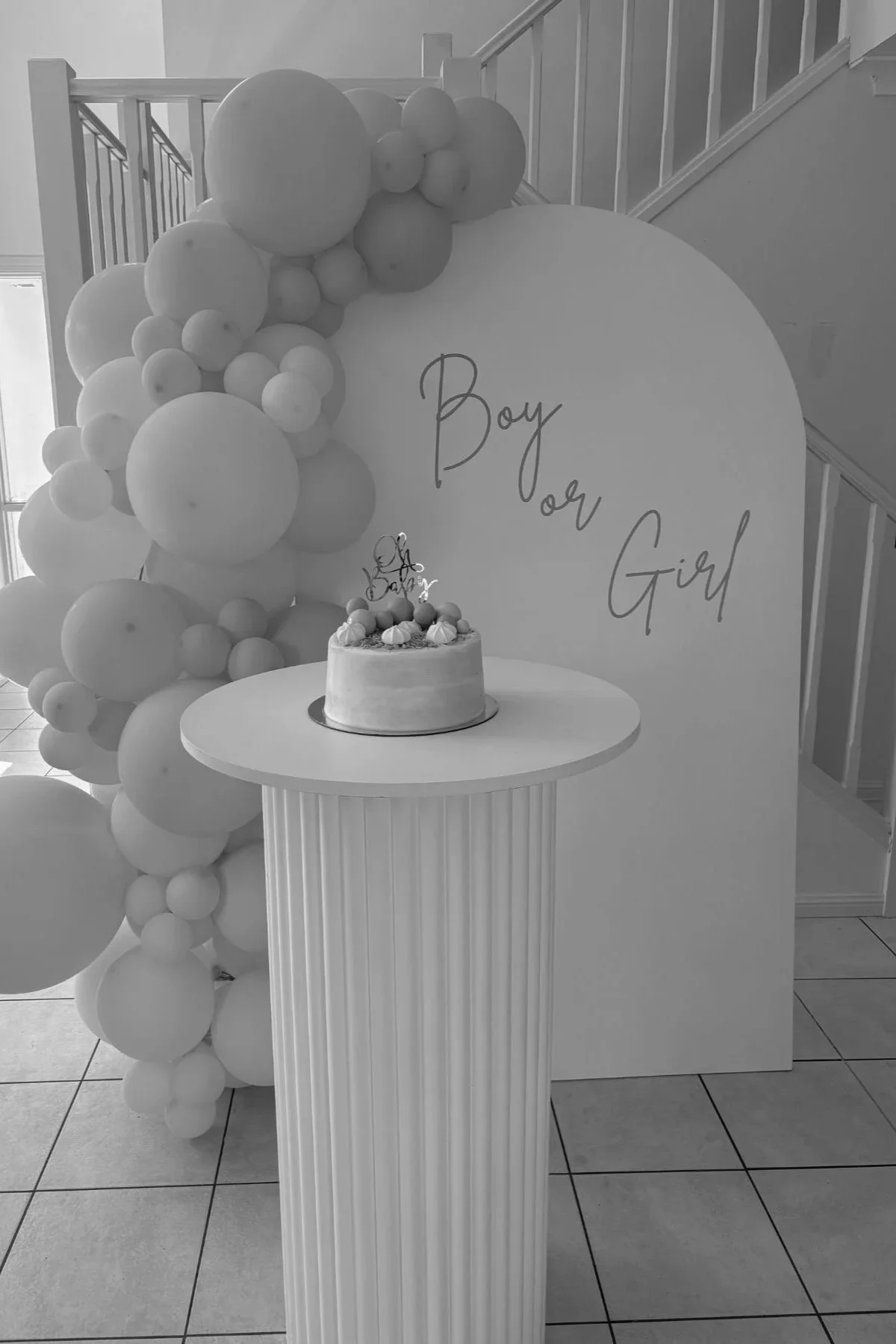 Gender reveal balloon backdrop with custom signage and plinth styling by Saudade Events, Gold Coast balloon stylist.