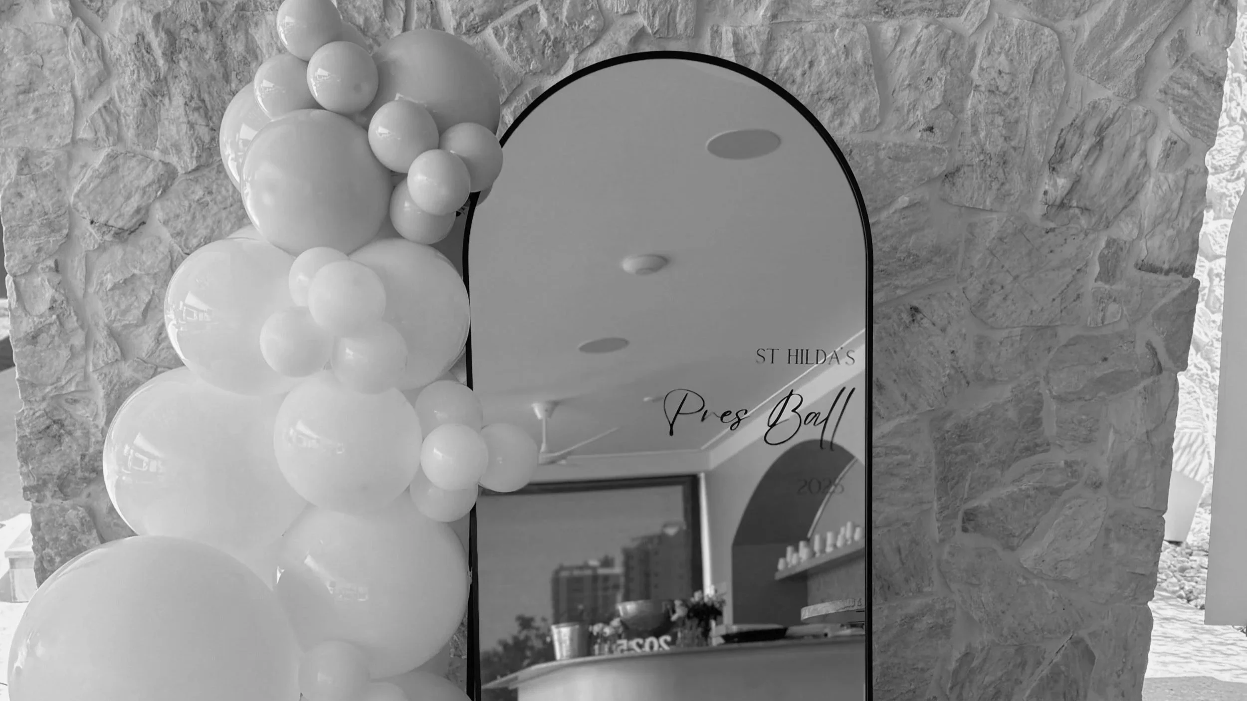 Organic balloon garland installation for a Gold Coast event, styled by Saudade Events.