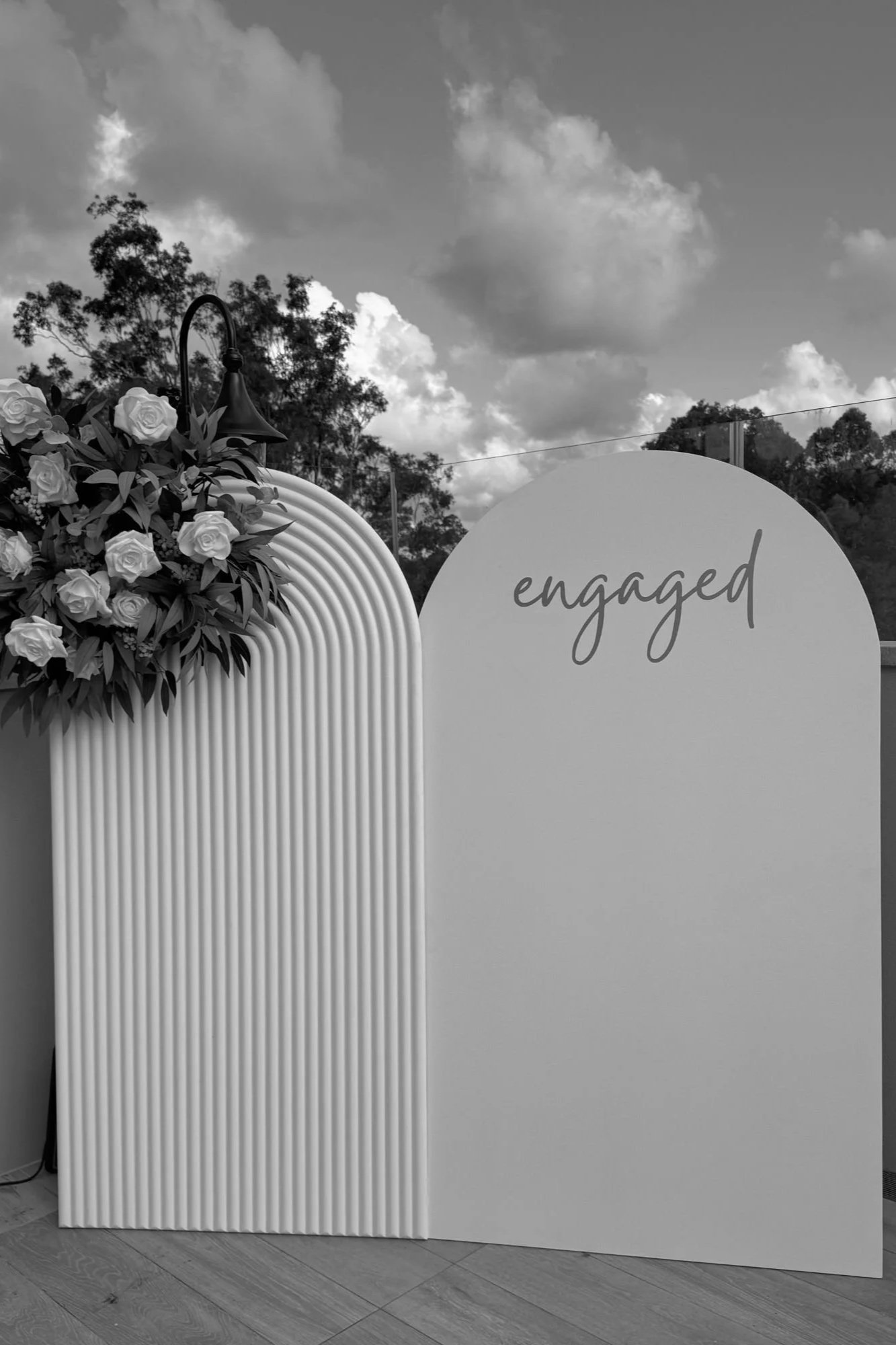 Modern engagement party backdrop styling with custom “engaged” signage and florals by Saudade Events on the Gold Coast.