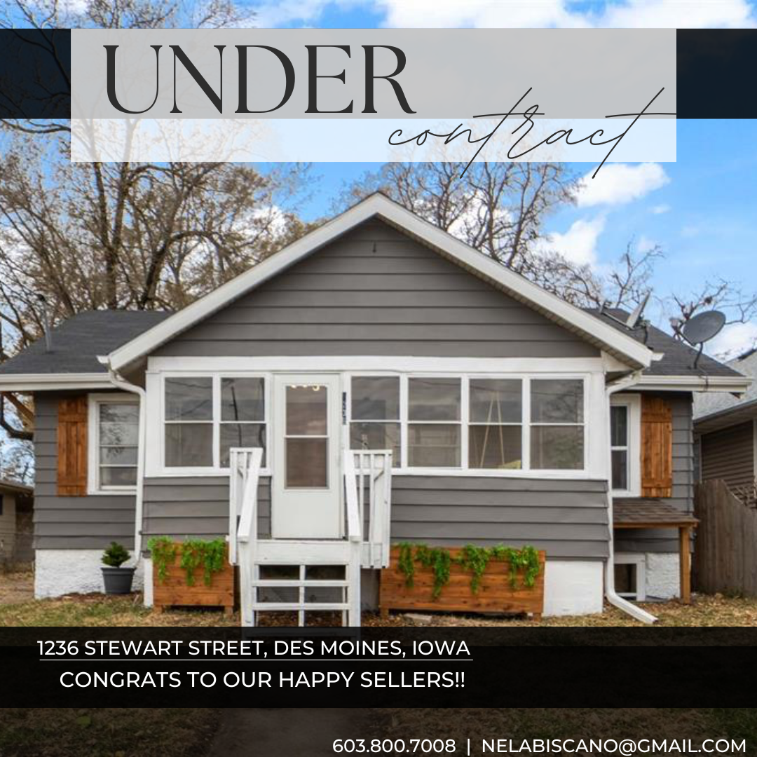 A house with gray siding and white trim with front stairs, large porch, and potted plants in planters, trees in the background, and a cloudy sky.