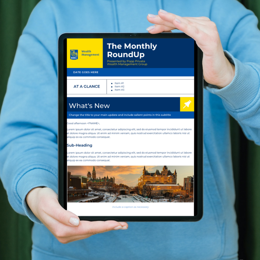 Person holding a tablet displaying a newsletter titled 'The Monthly RoundUp' from with sections 'At a Glance' and 'What's New', and a photo of a cityscape at sunset.